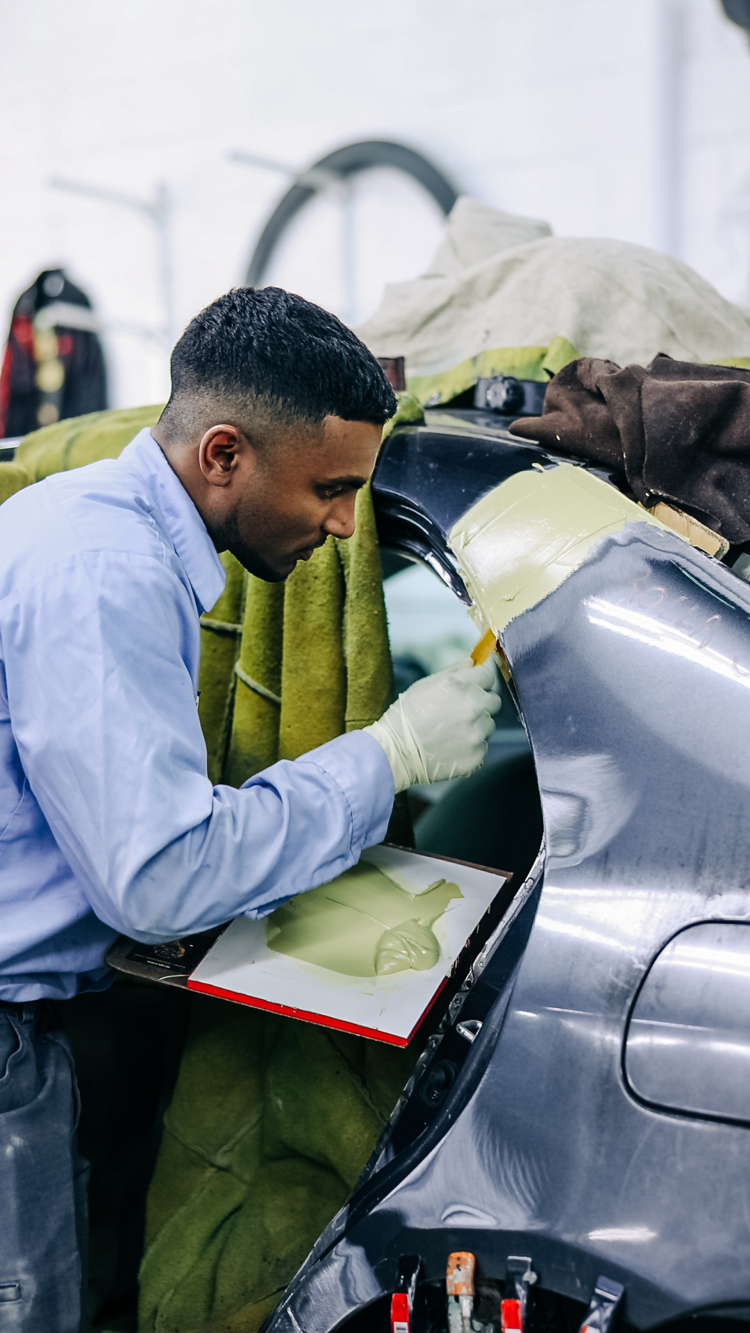 Vehicle on frame straightening rack for collision repair at Quality Auto Body in Fairfax, VA