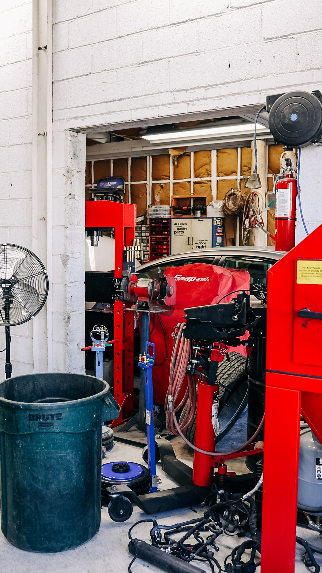 Vehicle on lift at Quality Auto Body shop in Fairfax, VA