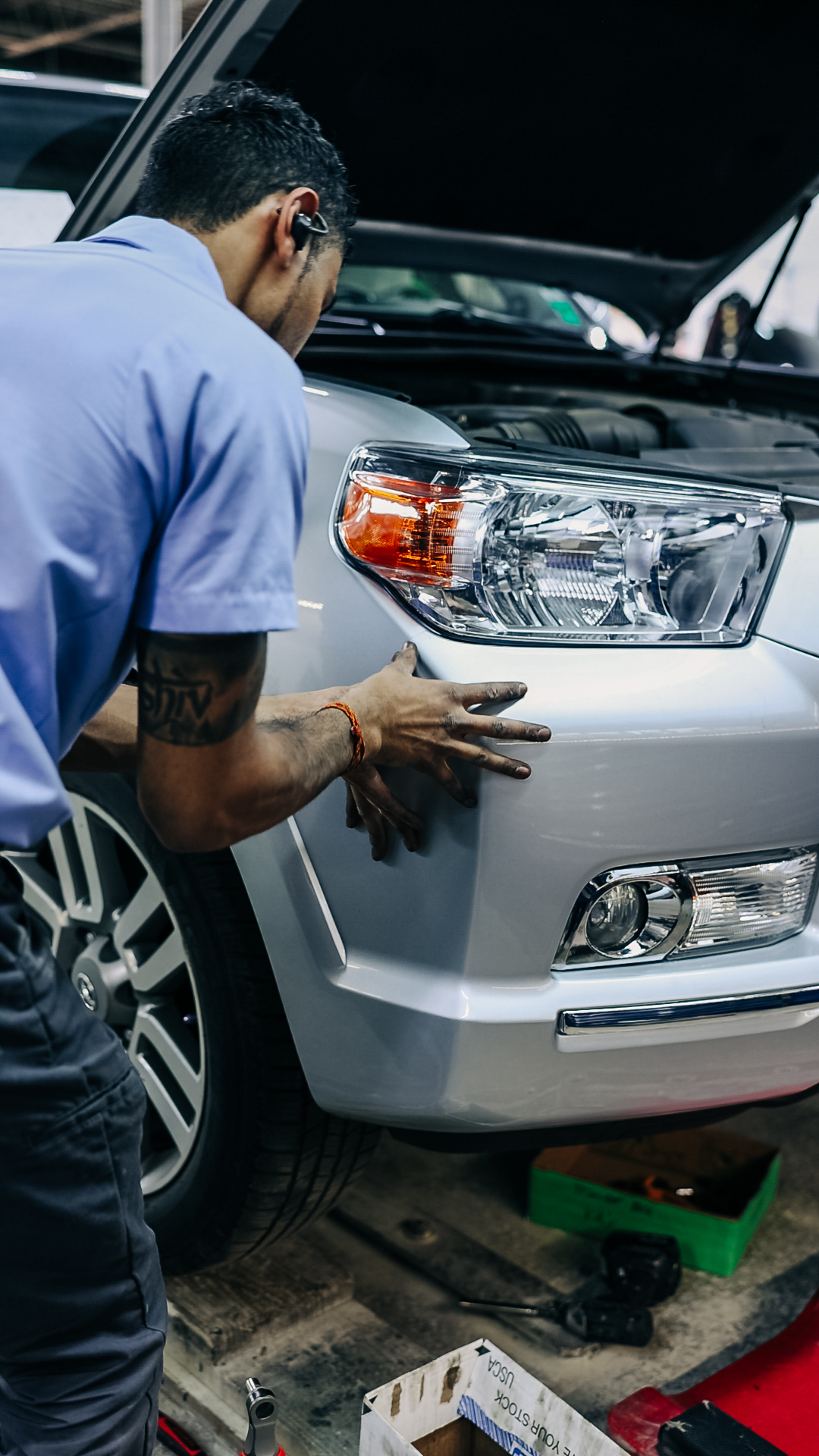 Quality Auto Body shop floor with vehicles being repaired under insurance claims in Fairfax, VA
