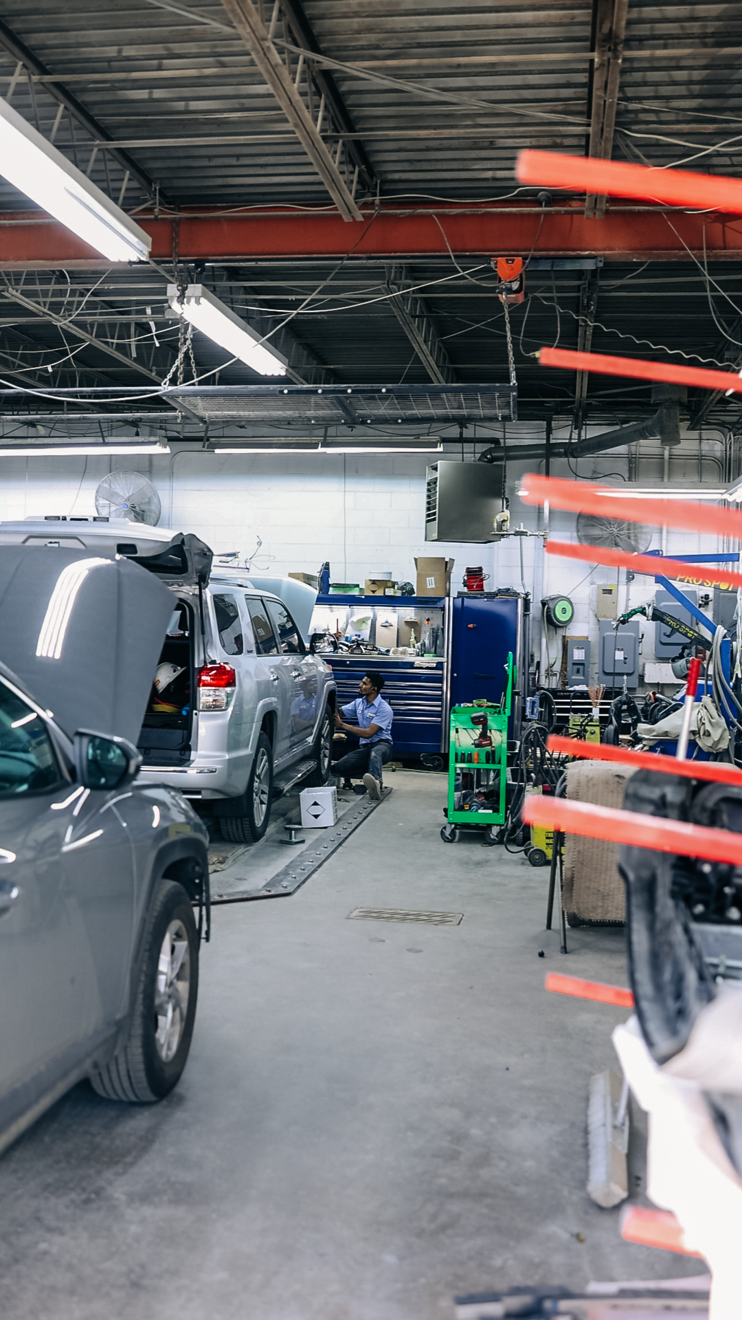 Technician repairing vehicle bumper as part of insurance claim at Quality Auto Body in Fairfax, VA